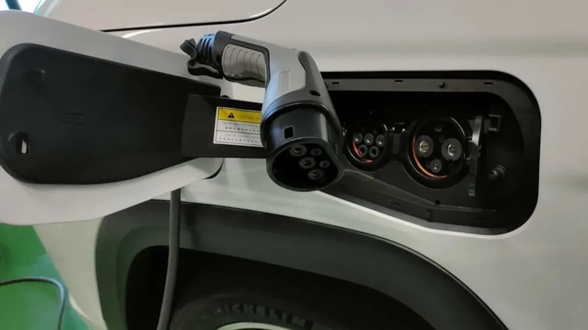 Conector Tipo 2 de carro elétrico sendo inserido no veículo
